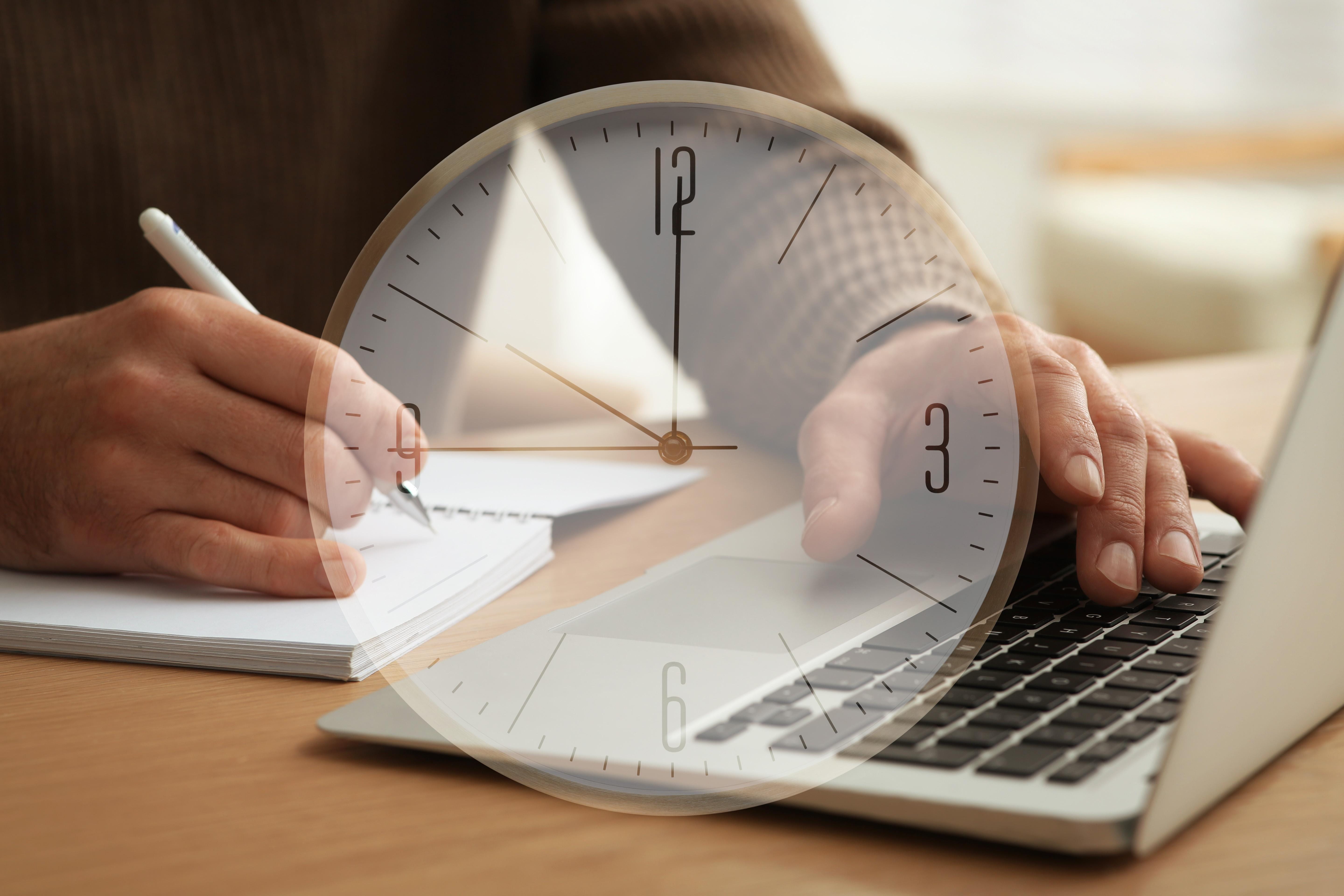 A person actively working at a clean desk
